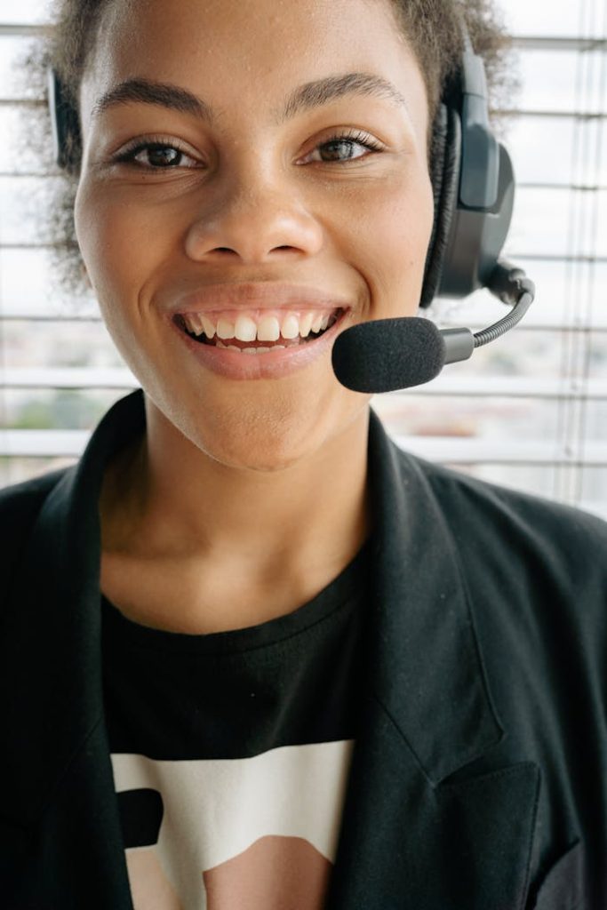 woman-wearing-a-headset-with-microphone-8866770 Smiling woman in a headset offering excellent customer service from indoors.